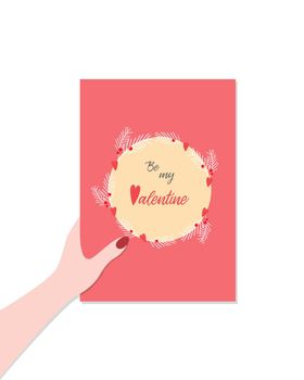 Hand holds a greeting card for Valentines Day, the inscription be my Valentine. isolated, white background.