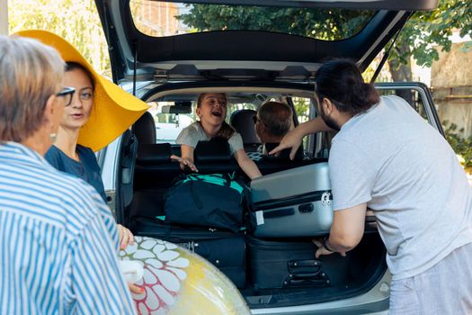 Excited family travelling on vacation by car