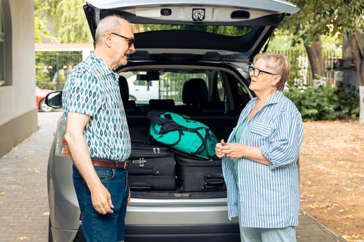 Retired people travelling on vacation by car