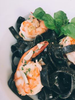 black spaghetti with prawn - pasta and italian cuisine recipes styled concept
