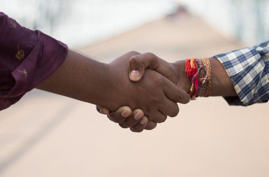 Friends shake hands. Closeup . Friendship handshake outdoor.