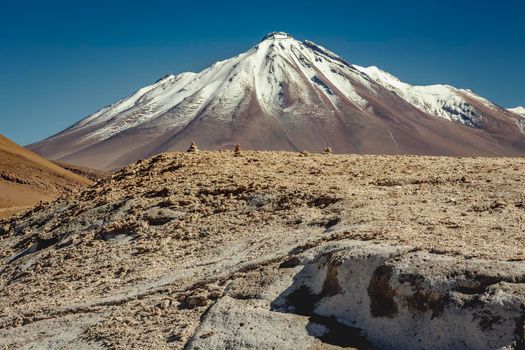 Atacama desert, snowcapped volcano and arid landscape in Northern Chile