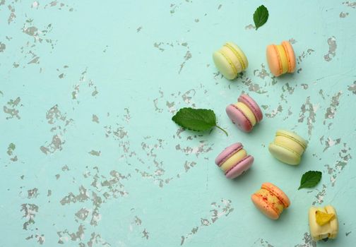 baked macarons with different flavors on a green background