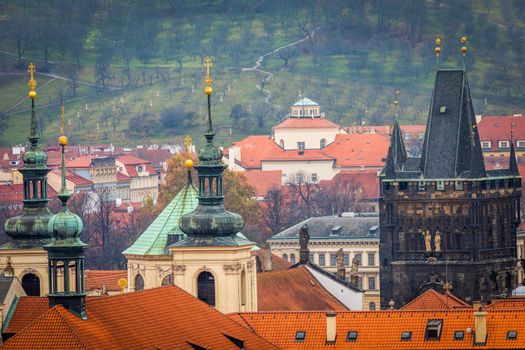 Above medieval Prague old town towers and domes at evening, Czech