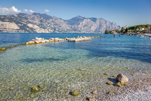 Idyllic lake Garda coastline in Malcesine with translucent waters, Italy
