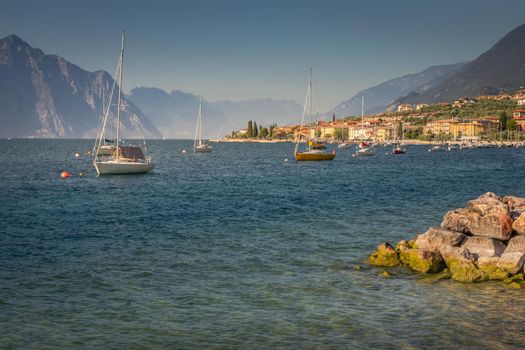 Idyllic lake Garda coastline in Malcesine with sailboats, Northern Italy