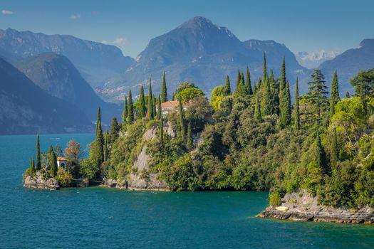 Idyllic lake Garda coastline in Malcesine with cypress trees, Northern Italy