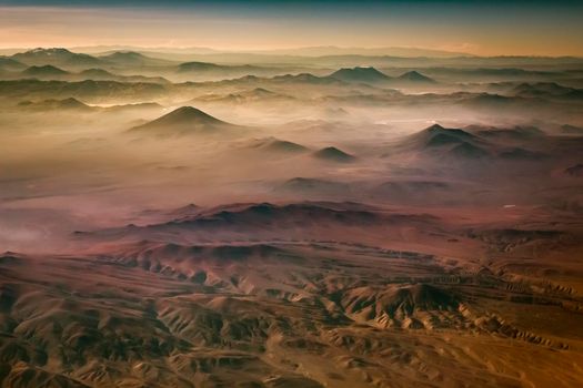 Aerial Atacama desert, snowcapped volcanoes and arid landscape in Chile