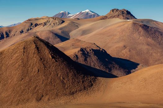 Atacama desert, snowcapped volcanoes and arid landscape in Northern Chile