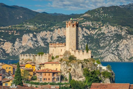Idyllic Lake Garda above Malcesine old town with Italian flag and mountain range