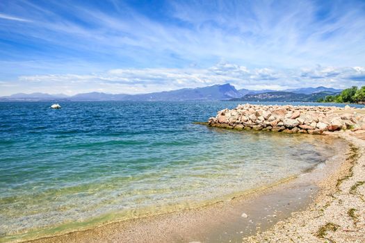 Idyllic lake Garda coastline in Lazise with boat, Northern Italy