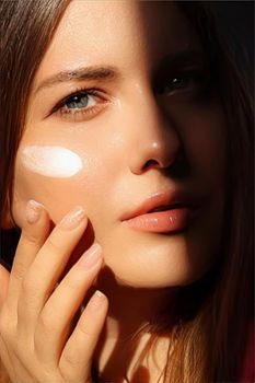 Beauty, suntan spf and skincare cosmetics model face portrait, woman with moisturising cream, sunscreen product or sun tan lotion on her cheek, luxury facial and skin care