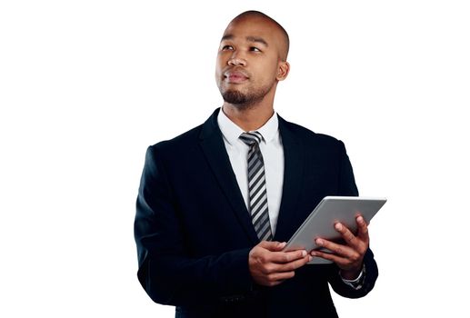 Guaranteed to gain success. Studio shot of a handsome young businessman using a tablet against a white background.