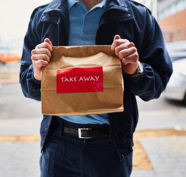 On time and delicious. an unrecognizable man delivering take away food.
