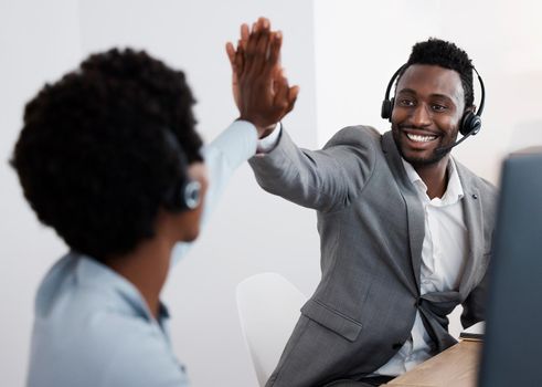 High five, congratulations and success with support staff or customer service personnel working together in a call center. Closing a deal, making a sale solving a problem to help and assist online