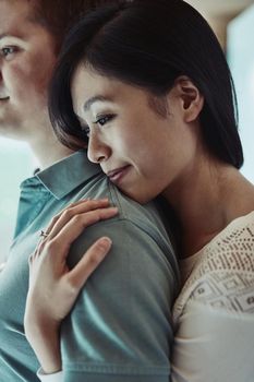 This is my shoulder to lean on. an attractive young woman embracing her husband from behind.