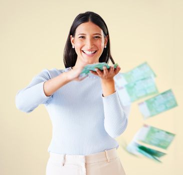 . Wealthy, rich and happy woman throwing money smiling about her financial success and freedom. Portrait of an excited young female having fun and enjoying her cash and ready to spend.