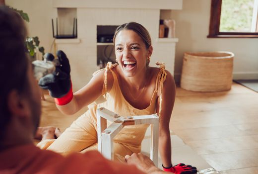Flirting playful girlfriend teases boyfriend, moving to apartment, remodel construction furniture and diy interior design building. Laughing and happy couple love having fun redecorate lounge.