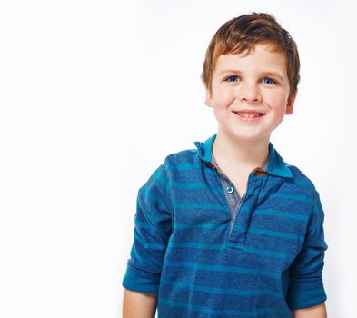 Hes such a charmer already. Studio shot of a young kid against a grey background.
