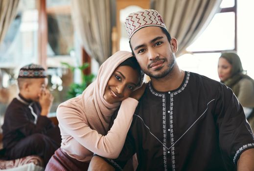 Married muslim couple together with family celebrating islamic religious holiday event wishing an eid mubarak or ramadan kareem. Traditional, and cultural in love husband and wife sitting at home