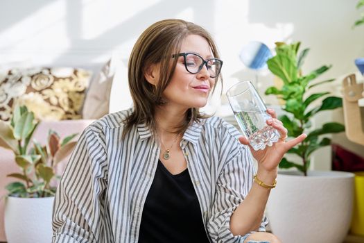 Smiling mature woman with a glass of water