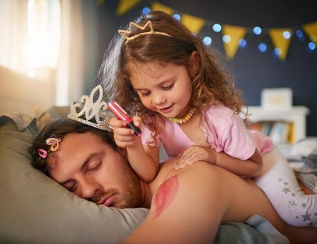 Shes an artist and Dads the canvas. an adorable little girl drawing with lipstick on her fathers arm while he sleeps.