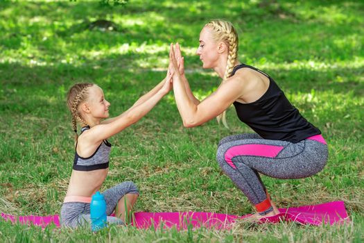 Mother and daughter doing sports exercises
