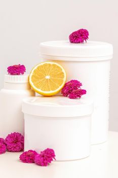 Jars with fresh lemon and flowers