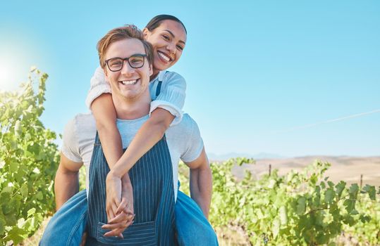 Happy and playful interracial farming couple with smile bonding with piggy back. Business people, man and woman agriculture worker in farming industry or nature on a grape farm during summer in love