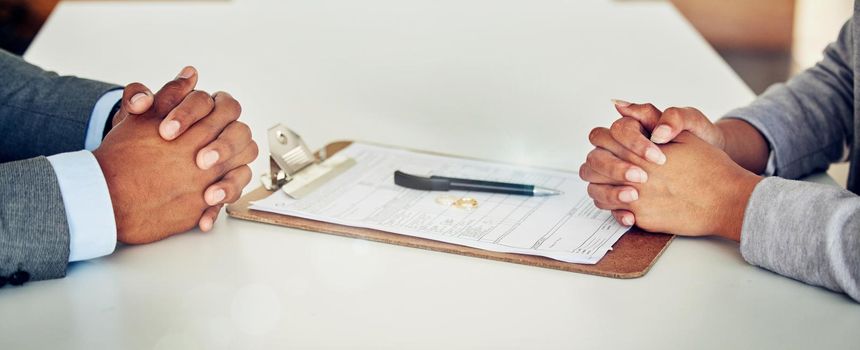 Couple hand sign legal divorce documents, contract or paper deal in a lawyer office with ring placed on table. Woman and man with signature on marriage paperwork after agreement at family law office