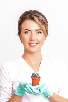 Beautician holding a small cactus