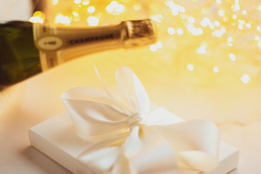 The bottle of champagne and holiday gift box