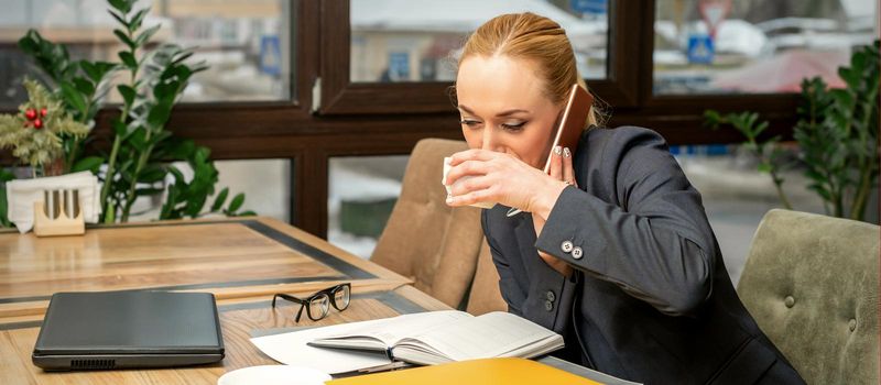 Busy business woman drinking coffee
