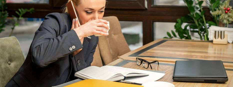 Busy business woman drinking coffee