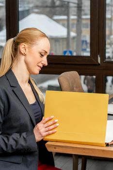 Young businesswoman looking at folder