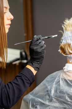 Female hairdresser dyeing short hair