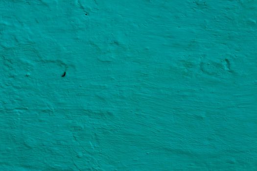 Blue-green plaster on the wall.