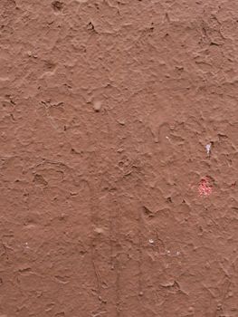 Wall surface with old damaged brown plaster.