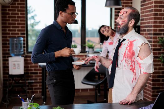 Evil zombie talking to businessman in office