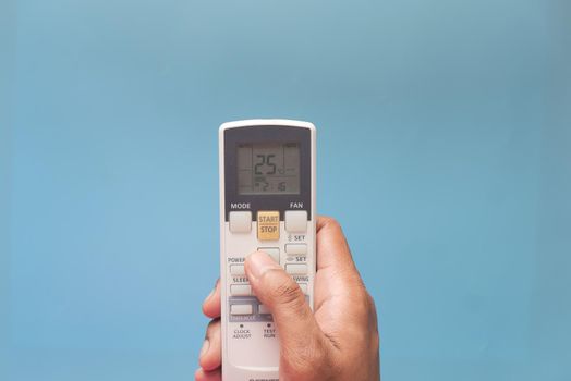 Close up of man hand holding air condition remote.