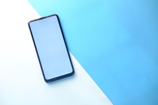 top view of smart phone on color background