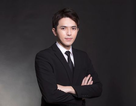 Young Asian handsome Business man in black suit