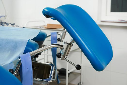 Gynecological room with chair and equipment in modern clinic