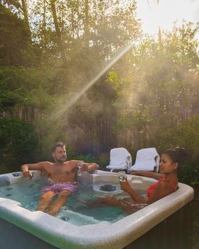 couple in hot tub bath in the rain forest of Vancouver Island, men and women in jacuzzi