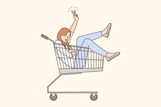 Smiling woman riding in supermarket cart