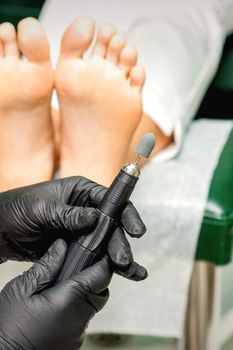 Chiropodist prepares foot file machin