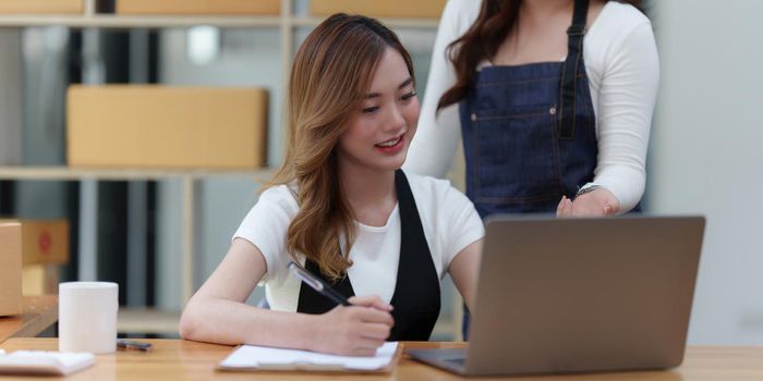 Asian SME business woman with partner working at home office. online shopping concept