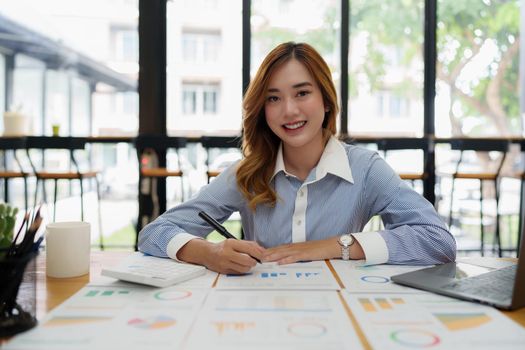 Modern asian business woman analysis financial paperwork document