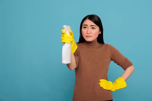 Confidence satisfied asian young woman holding spray