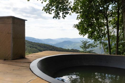Wooden hot vat on terrace at mountains. vacation concept with hot bath outside. summer